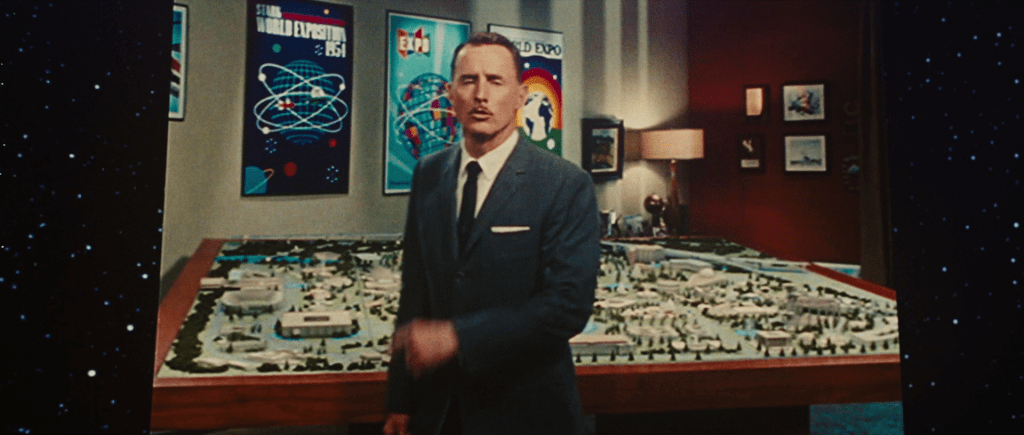 Archival footage of Howard Stark standing in from of a poster for the Stark World Exposition 1954.