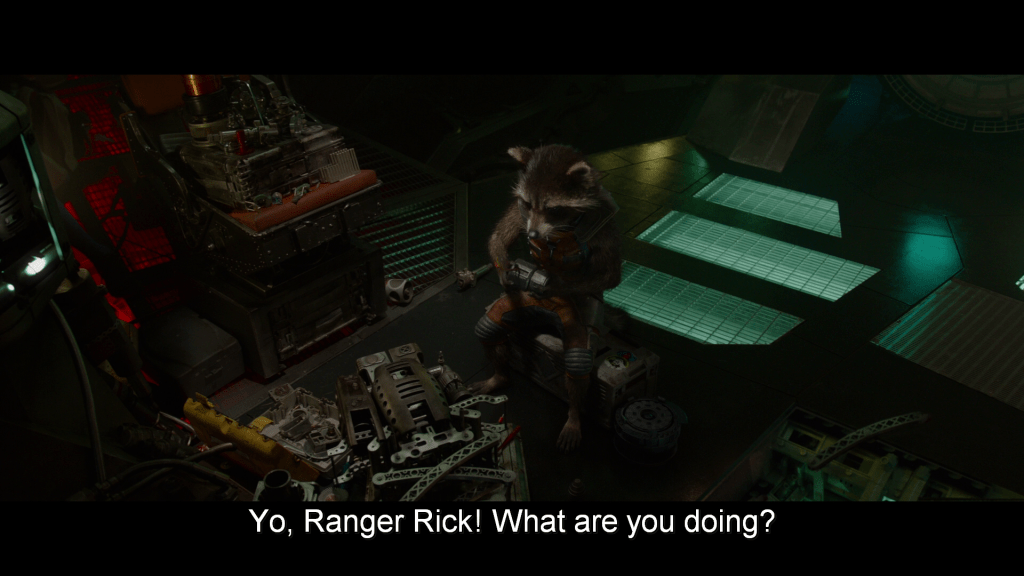 Rocket is making a weapon out of ship parts; Peter yells from off screen,