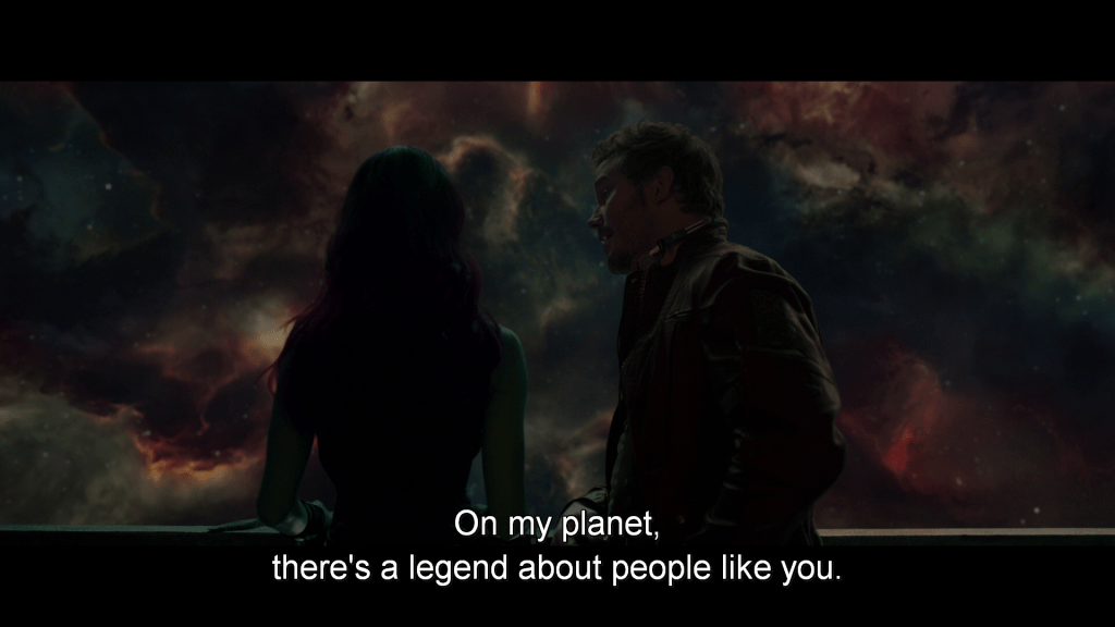 Peter talks to Gamora as she stares out at a nebula cloud.