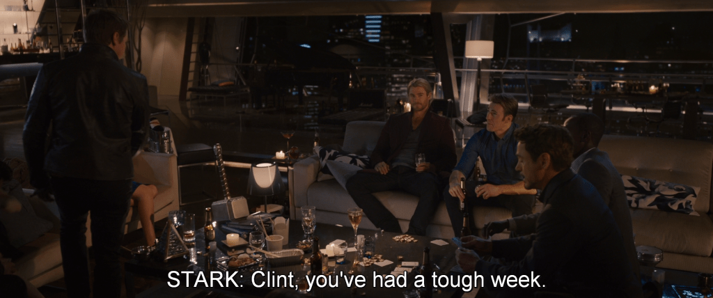 After the party, the Avengers gather around a table and take turns trying to lift Mjolnir. Stark teases Clint Barton, 