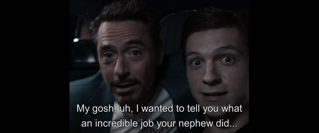 Tony Stark speaks into the camera next to Peter,